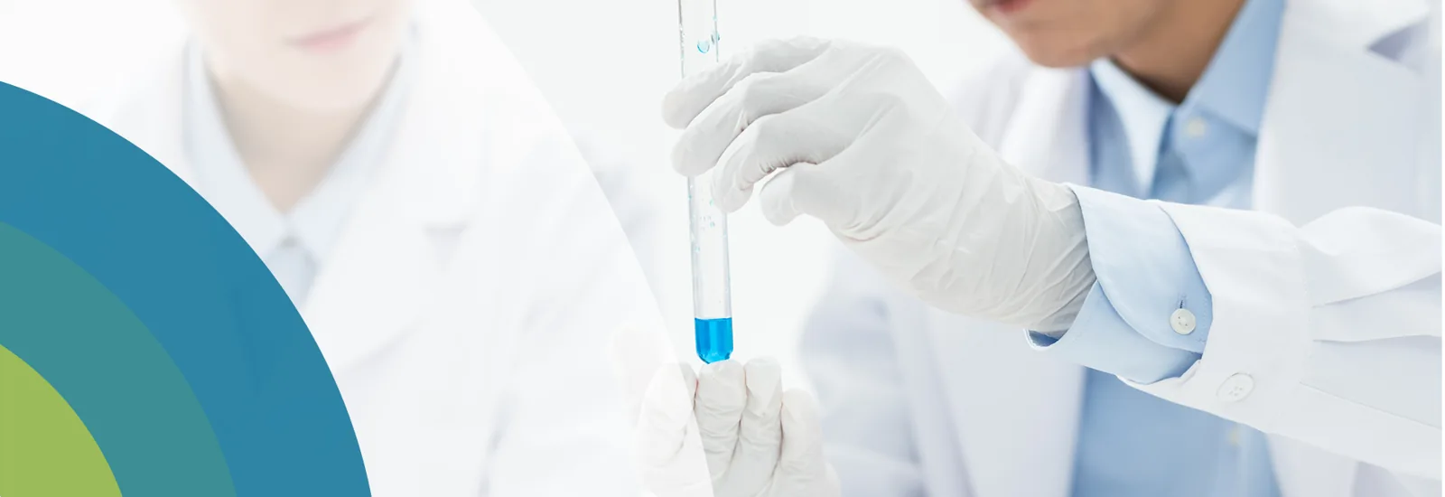 Laboratory workers examining a blue liquid sample, from the original HMC website