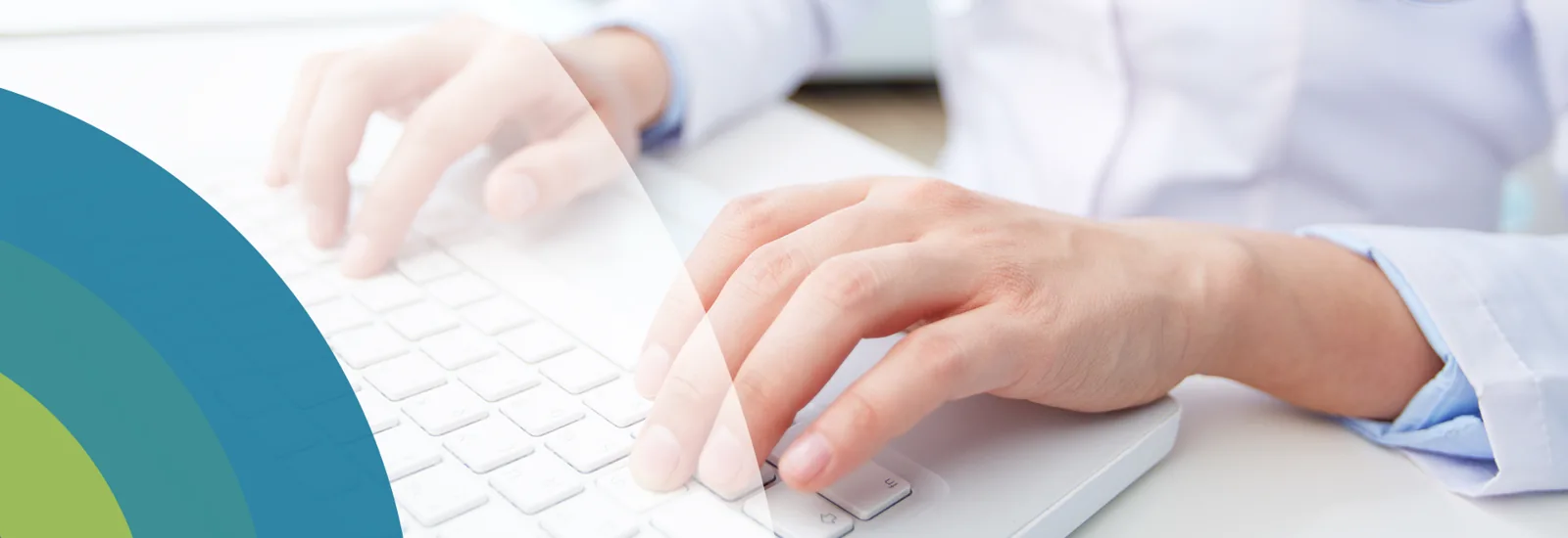 Hands typing on a white keyboard, from the original HMC website