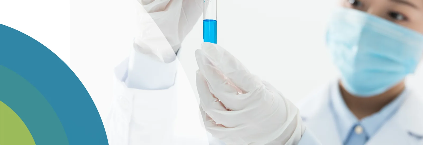 Laboratory worker holding a blue liquid sample, from the original HMC website